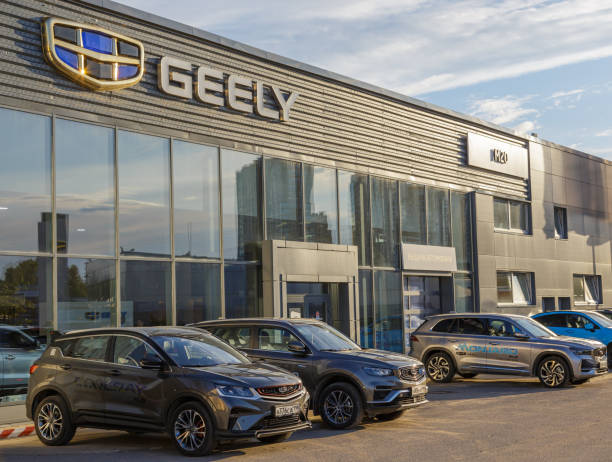 Дилерский центр Geely, демонстрирующий современные автомобили перед зданием под чистым небом.